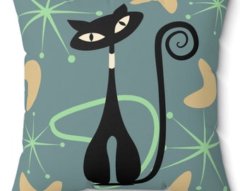 May include: A teal blue throw pillow with a black cat design. The cat has a white stripe on its chest and a curled tail. The background features a retro pattern of green and tan shapes.