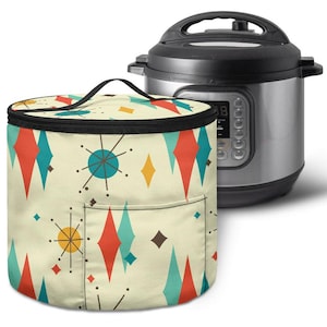 May include: A cream-colored, cylindrical appliance cover with a retro atomic design in red, teal, and yellow diamonds and starbursts. A black-handled bag is in front of a silver and black Instant Pot.