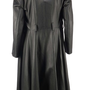 May include: A long black leather coat with a fitted waist and a flared skirt. The coat has a high collar and a button closure.