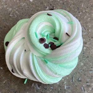 May include: Green and white slime with chocolate chips and green sprinkles.