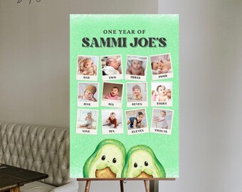 Pode incluir: Um cartaz verde e branco com o texto "One Year of Sammi Joe's" e doze fotos de um bebê em uma moldura branca. As fotos estão dispostas em uma grade com a idade do bebê em meses abaixo de cada foto. O cartaz está em um cavalete de madeira.