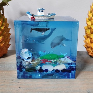 Ocean Resin Whale Cube with a Boat, Turtle, Lobster, 4 Whales, a Stingray, a Shipwreck, Starfish and Shells