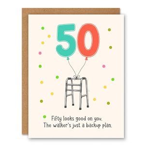 May include: A greeting card featuring a teal number 5 and a coral number 0 shaped like balloons tied to a silver walker. The card has colorful confetti dots and the text: Fifty looks good on you. The walker's just a backup plan.