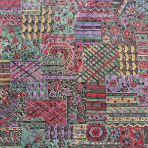 May include: A textile fabric featuring a dense patchwork design composed of various rectangular and hexagonal segments. The pattern includes floral motifs, geometric grids, horizontal stripes, and scalloped shapes in red, green, purple, and gold.