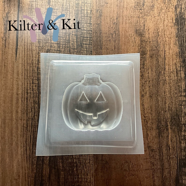 May include: Clear plastic mold shaped like a jack-o'-lantern with a smiling face.