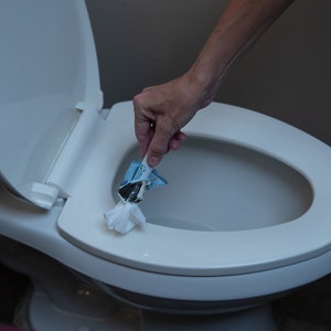 Pipiwipe: A 75% alcohol wet wipe with a Handle to clean public toilet seats and other surfaces, travel size, travel accessories, airplane.