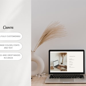 May include: A laptop computer displaying a website with the text "CONTACT US" and a phone number, email address, and website address. The laptop is on a wooden desk with a vase of dried pampas grass, a pair of glasses, and a cup of coffee.