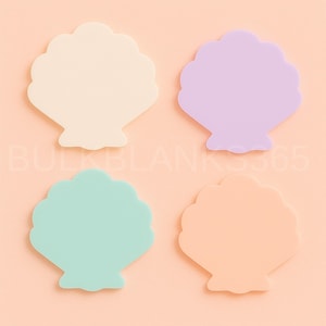 May include: Four seashell-shaped objects in pastel colors: cream, lavender, mint green, and peach. The objects are arranged on a light orange background. The text "BULKBLANKS365" is partially visible in the image.