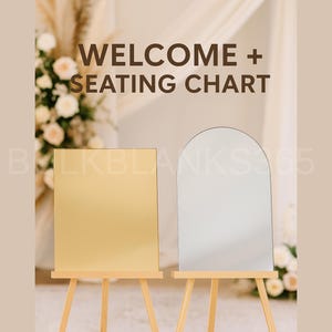 May include: Two blank signs on wooden easels. One is a gold square, the other is a silver arched shape. The words "WELCOME + SEATING CHART" are printed in brown. The background includes floral arrangements and draped fabric.
