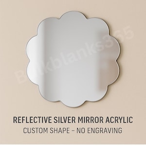 May include: A reflective silver acrylic mirror in a custom, scalloped shape. The mirror has a smooth, polished surface and is displayed against a neutral background. Text at the bottom reads: "REFLECTIVE SILVER MIRROR ACRYLIC CUSTOM SHAPE - NO ENGRAVING."