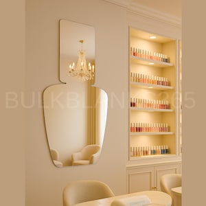 May include: A nail polish bottle-shaped mirror hangs on a beige wall, reflecting a chandelier and chairs. A built-in cabinet displays rows of nail polish bottles in various colors. The text "BULKBLING205" is visible.