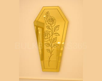 May include: A gold-colored, coffin-shaped mirror with a floral rose design etched on the surface. The mirror is mounted on a light-colored wall. The text "BULK" and "KS365" is visible on the wall.