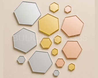 May include: An assortment of hexagon-shaped mirrors in various sizes and metallic finishes, including silver, gold, and rose gold. The mirrors are arranged on a neutral background, creating a modern and geometric aesthetic.