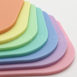 May include: A stack of colorful, rounded-corner rectangles in a rainbow of pastel shades: peach, yellow, green, teal, blue, lavender, and pink. The image includes the text "BULKBLANKS365".