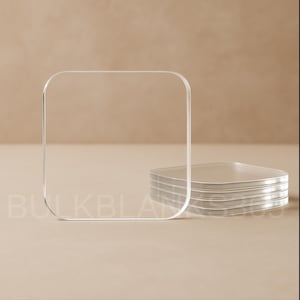 May include: Clear acrylic square coasters, stacked and standing upright. The coasters have rounded corners and are displayed on a neutral background. The word "BULKBLANKS" is visible in the lower left corner.