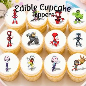 May include: A selection of cupcakes with white icing, each topped with edible superhero characters. The toppers depict characters like Spider-Man and the Hulk. The cupcakes are arranged on a white plate, with the text "Edible Cupcake Toppers" displayed above.
