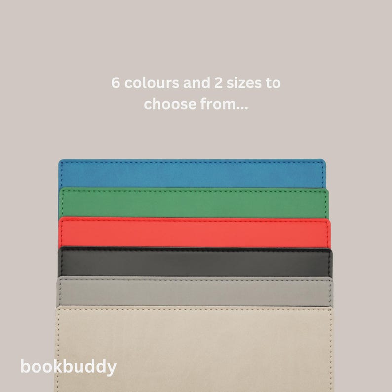 May include: Six bookends in different colors, including blue, green, red, black, gray, and beige. The bookends are stacked on top of each other. The text "bookbuddy" is at the bottom of the image. The text "6 colours and 2 sizes to choose from..." is at the top of the image.