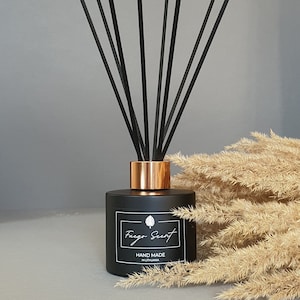 May include: Black diffuser bottle with a copper lid and black reeds. The bottle has a white label with the text "Fuego Scent" and "Hand Made in Lithuania".