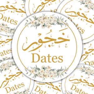 May include: White circular stickers featuring gold Arabic script and the English word "Dates". Each sticker is adorned with a floral wreath of white flowers and green foliage. The stickers are arranged in a scattered pattern.