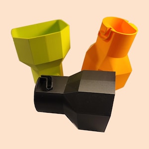May include: Three 3D printed adapters in lime green, bright orange, and matte black. Each adapter features a wide, faceted, funnel-like opening on one end and a smaller, cylindrical connection point with a distinct notched locking mechanism on the other.