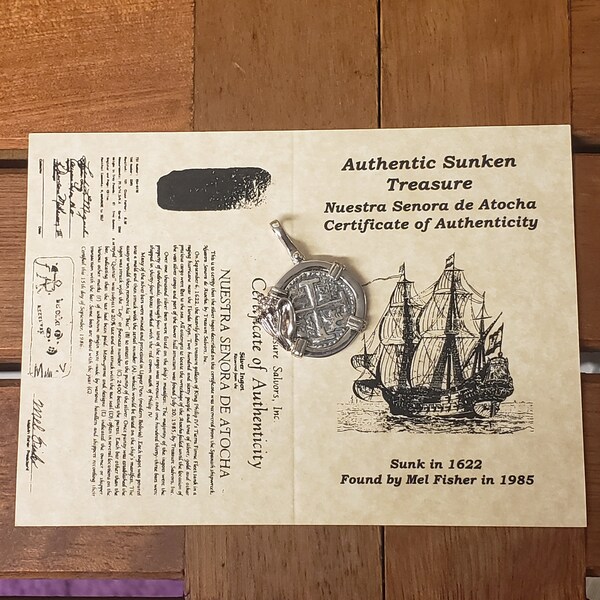 Authentic Atocha silver shipwreck coin replica with conch shell