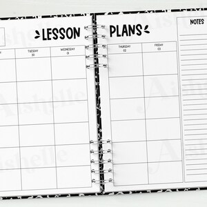 May include: Open lesson plan notebook with a black and white patterned cover. The notebook is open to a spread with the words "Lesson Plans" and a calendar layout. A pencil and binder clips are on the side.