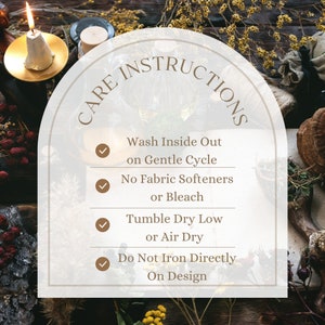 May include: Care instructions for a fabric item. The instructions are: Wash inside out on gentle cycle, no fabric softeners or bleach, tumble dry low or air dry, do not iron directly on design.