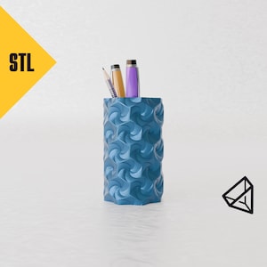 May include: A blue, geometric patterned pencil holder with three writing implements inside. The holder is made of 3D printed plastic.