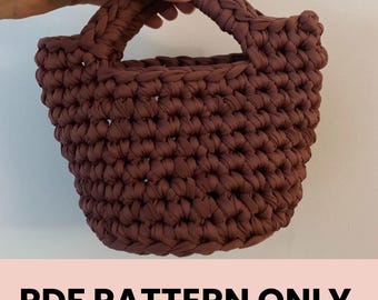 May include: A brown crocheted tote bag with a single handle. The bag is made with a thick yarn and has a simple, classic design. PDF PATTERN ONLY.