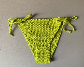 May include: Lime green crochet bikini bottom with ties on each side.