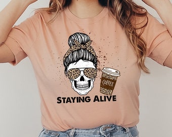 ステイイング アライブ T シャツ、おもしろスカル シャツ、スケルトン ジョーク T シャツ、ハロウィン トップ、クリスマス シャツ、ステイイング アライブ コーヒー T シャツ、コーヒーを飲む人シャツ