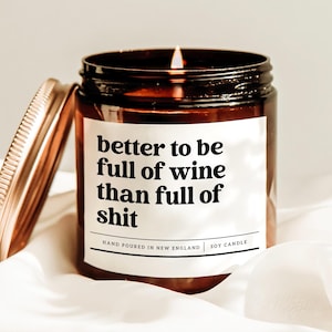a jar of wine sitting on top of a white sheet