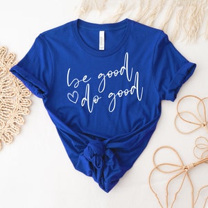 May include: A royal blue t-shirt with the text "be good do good" in white script with a small heart symbol before "do".