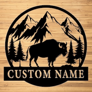 May include: Black metal silhouette of a bison standing in front of a mountain range with pine trees on either side. The text "CUSTOM NAME" is below the image.