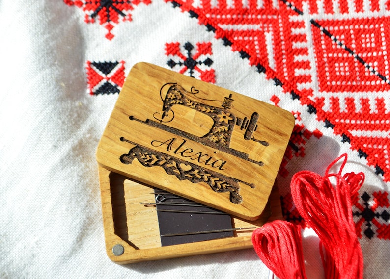wooden box for needles with magnet band, lid of the box held on magnets, on the lid engraved picture and name