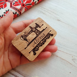 May include: A wooden plaque with a laser-engraved image of a sewing machine and the name "Alexa".