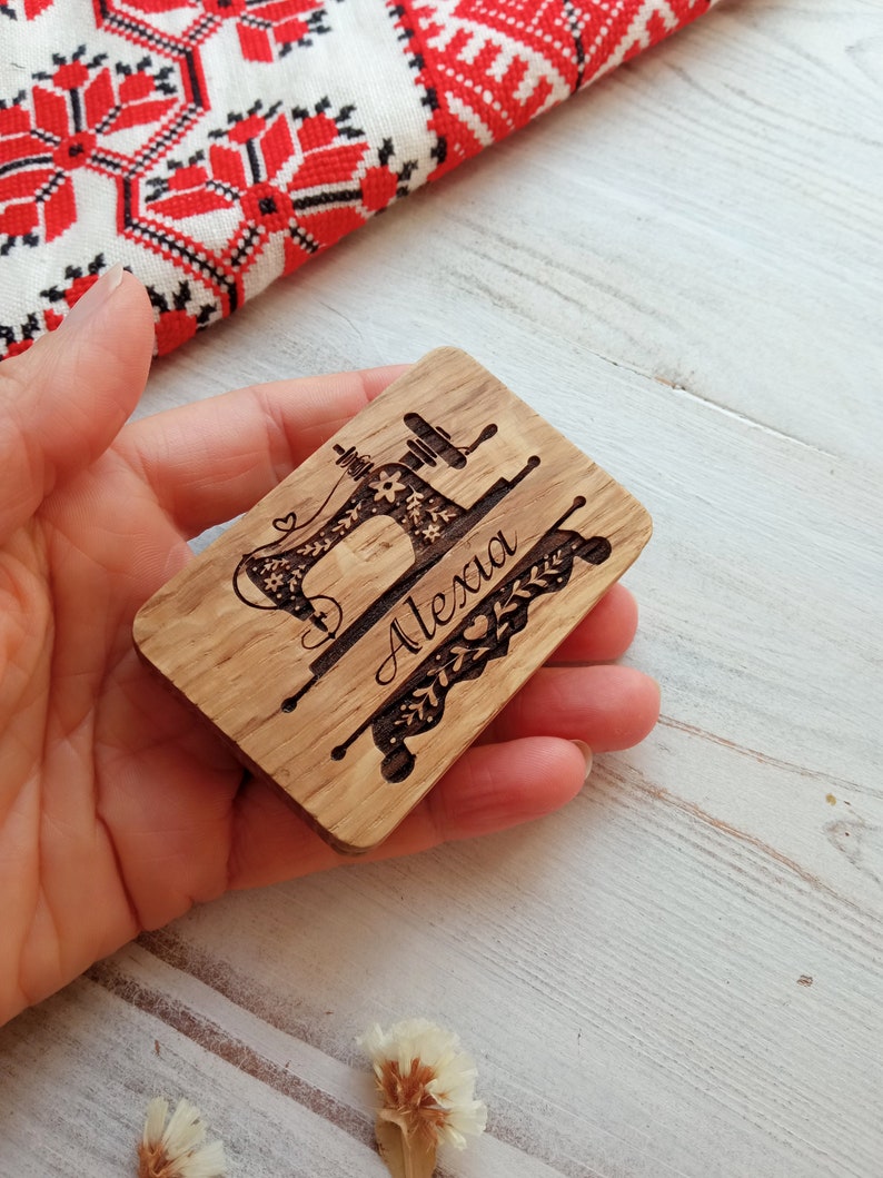 May include: A wooden plaque with a laser-engraved image of a sewing machine and the name "Alexa".