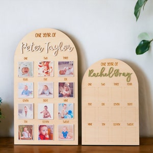 May include: Two wooden photo display boards with arched tops. The boards are decorated with the words "One Year of" and the names "Peter Taylor" and "Rachel Gray". Each board has 12 squares for photos, numbered one through twelve.