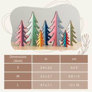 May include: A collection of eight freestanding wooden tree ornaments in various colours including pink, green, orange, blue, and white. A dimension chart lists sizes in cm as 6 x 9, 8.8 x 13, and 12 x 18 for small, medium, and large items.