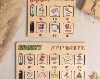 Puede incluir: Dos tablas de responsabilidades diarias de madera, una con la etiqueta "Sophia's" y la otra "William's". Cada tabla presenta tareas ilustradas como "Go for a Walk", "Brush Teeth" y "Eat Breakfast", con interruptores para marcar la finalización. Las tablas son de color marrón claro.