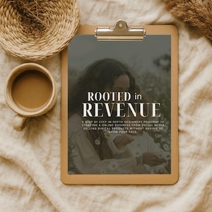 May include: A clipboard with the text "ROOTED in REVENUE" and a woman in a field of flowers. A cup of coffee and a woven basket are in the upper left corner. The text below the title reads: "A STEP BY STEP IN-DEPTH BEGINNERS ROADMAP TO STARTING A ONLINE BUSINESS FROM SOCIAL MEDIA SELLING DIGITAL PRODUCTS WITHOUT HAVING TO SHOW YOUR FACE."