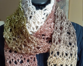 May include: A crocheted scarf in shades of brown, gold, and green. The scarf is made with a lacy stitch and has a soft, fuzzy texture.