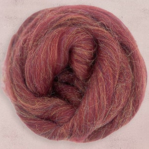 May include: A close-up of a ball of red, orange, and brown wool roving. The wool is soft and fluffy, and it is perfect for felting or spinning.