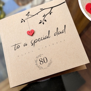 May include: A brown card with the text "to a special dad happy birthday 80" and two red heart-shaped buttons.