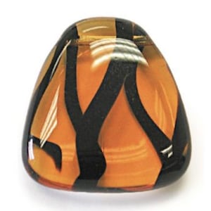 May include: A triangular, amber-colored glass pendant with black swirling lines. The pendant has a glossy finish.