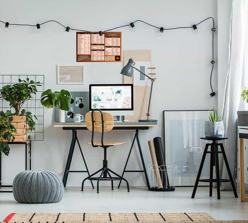 May include: A home office workspace with a computer, desk, chair, and plants. A poster with the Adobe Illustrator logo is hanging on the wall.