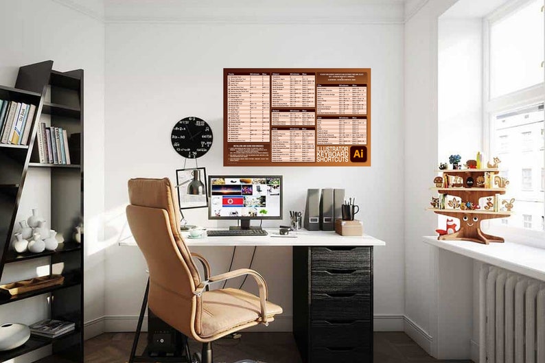 May include: A white desk with a black computer monitor, a brown office chair, a black lamp, and a brown poster with the text "Illustrator Keyboard Shortcuts" and the Adobe Illustrator logo. The poster is hanging on a white wall. There is a black bookshelf with books and decorative items on the left side of the image. A wooden tree-shaped shelf with decorative items is on the right side of the image.