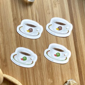 The Roost Coffee Cup Sticker ACNH Inspired | Available in Red/Green or Brown/Yellow on high-quality vinyl with a matte or glossy finish