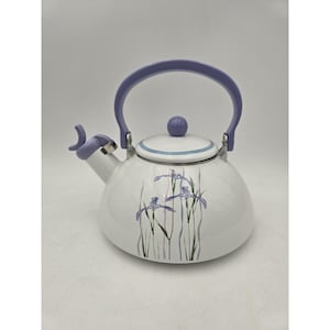 May include: A white stovetop kettle featuring a lavender handle, a matching lavender spout cover, and a lid with a lavender knob. The body is decorated with a botanical illustration of purple iris flowers and thin vertical pastel stripes.
