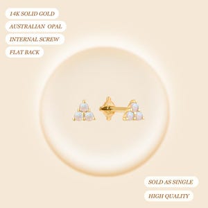 May include: A pair of gold earrings with a triangular design, each composed of three opals. The earrings are 14K solid gold and feature an internal screw and flat back. The text also mentions Australian opal.